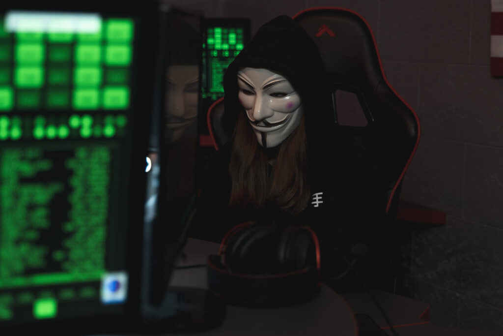 Person with mask sitting while using a computer