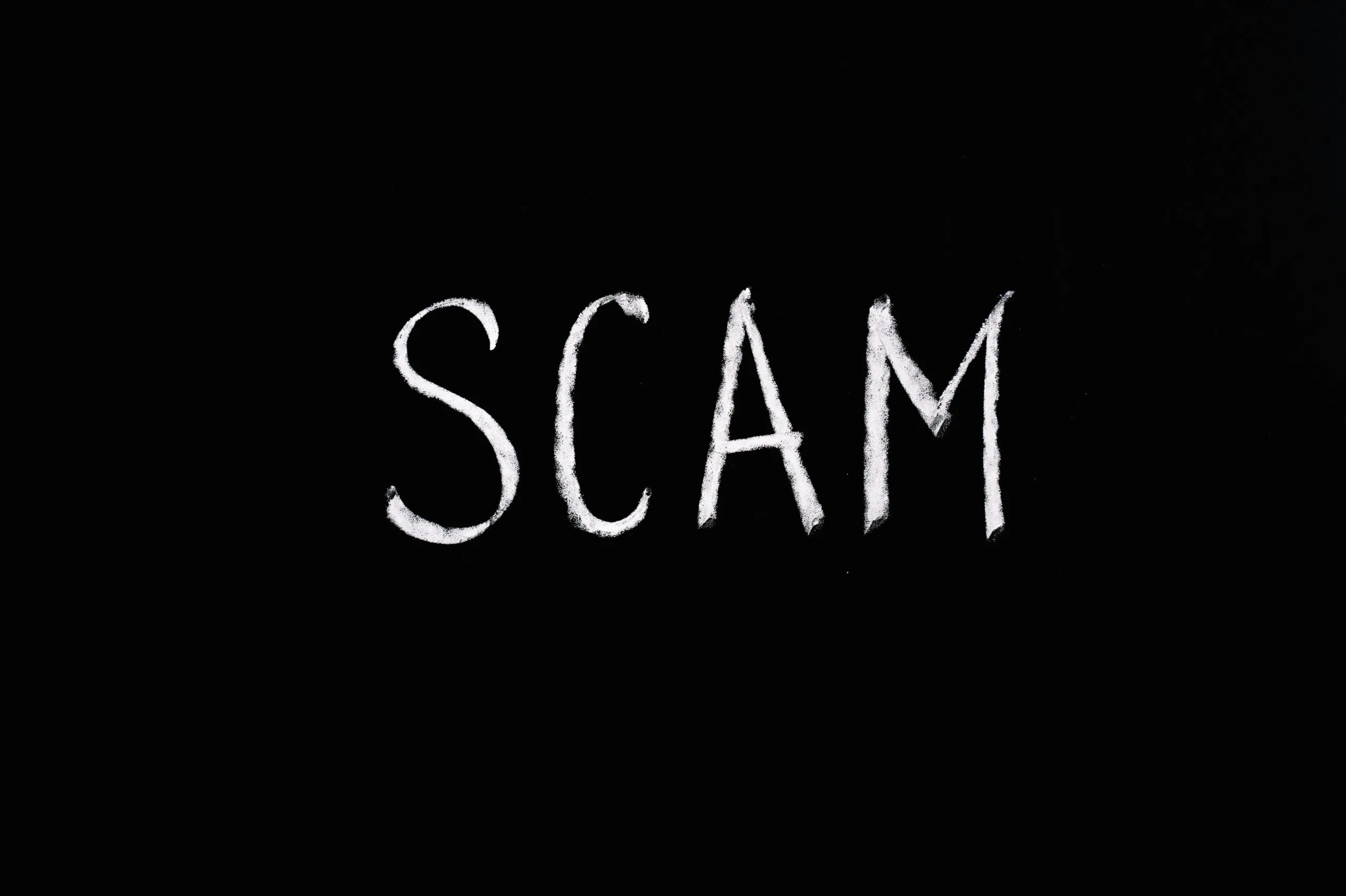 Scam lettering text on black background